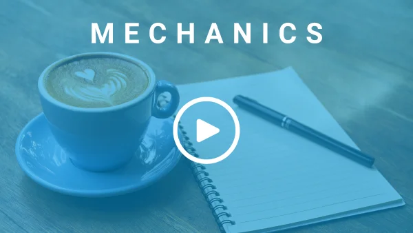 A cup of coffee, a pen, and an open notepad all placed on a wooden desk. There is a text overlay that reads 'Mechanics'.